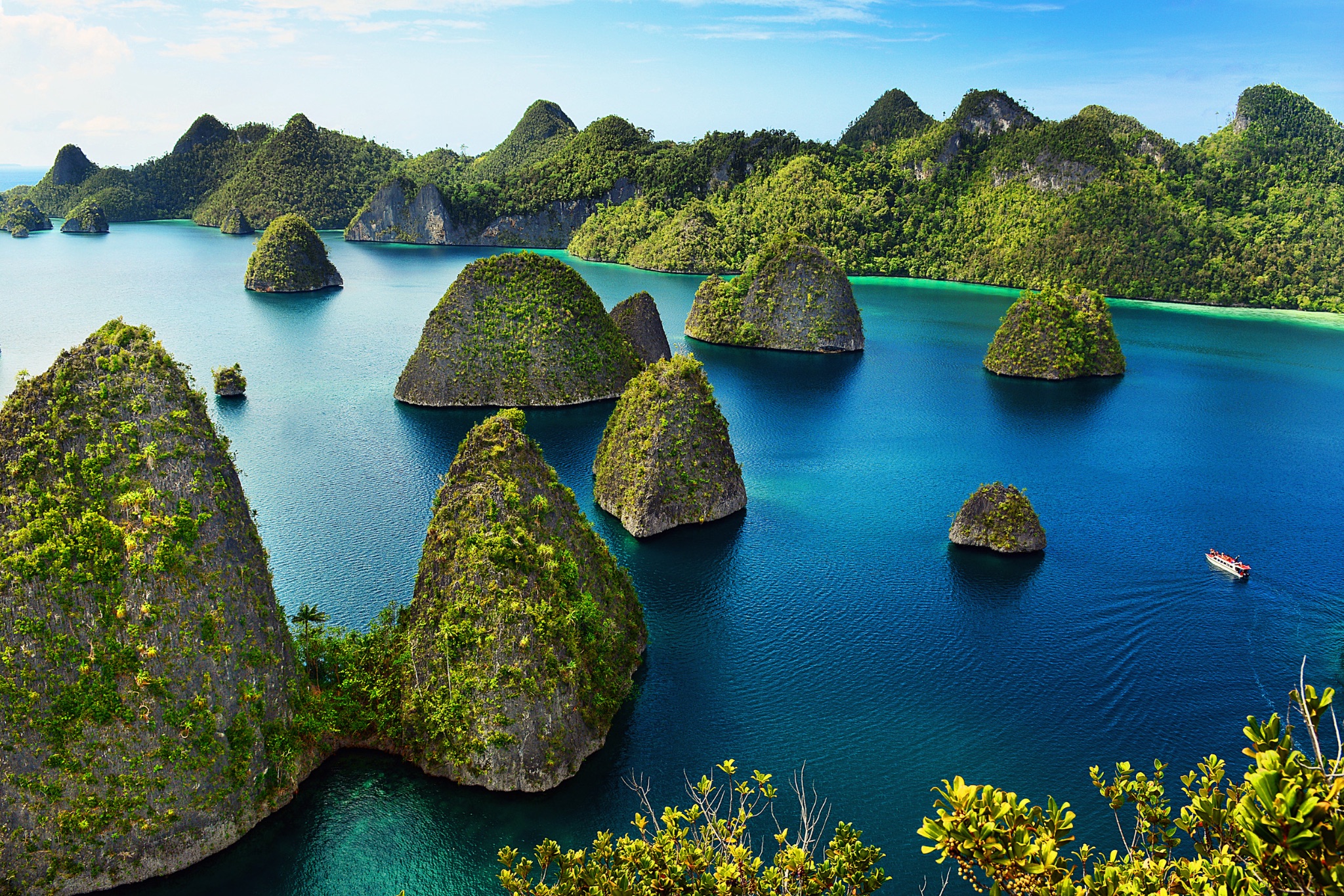 Aerial view of karst limestone islets and turquoise water in Raja Ampat, West Papua